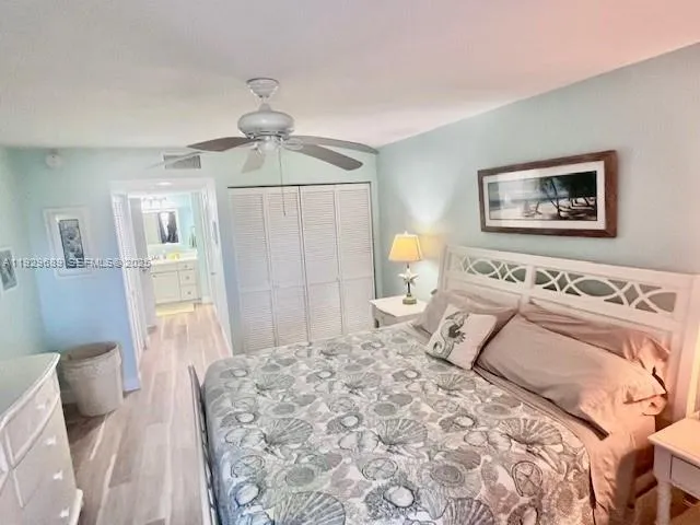 a bedroom with a bed and painting on the wall