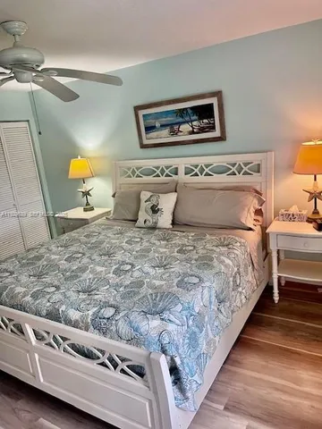 a bathroom with a granite countertop toilet a sink and mirror