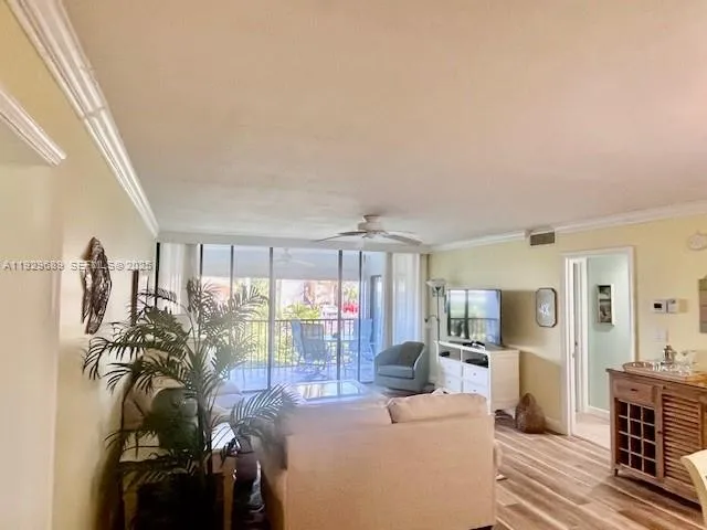 a living room with furniture and a floor to ceiling window