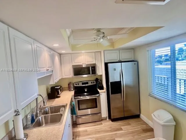 a kitchen with stainless steel appliances a refrigerator stove and microwave
