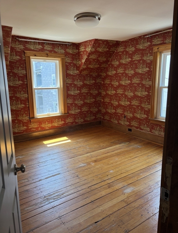 13 Moulton Street Lynn, MA 01905 - Photo 8 of 18 a view of an empty room with wooden floor and a window