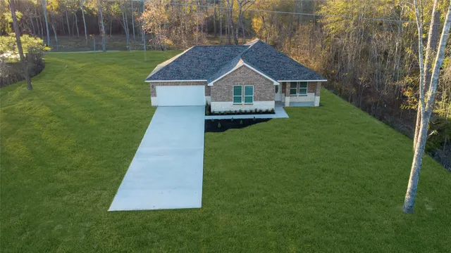 a view of house with backyard