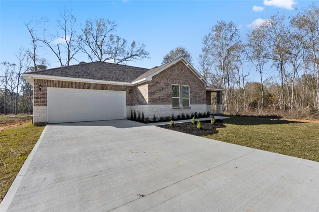 a front view of house with yard and trees