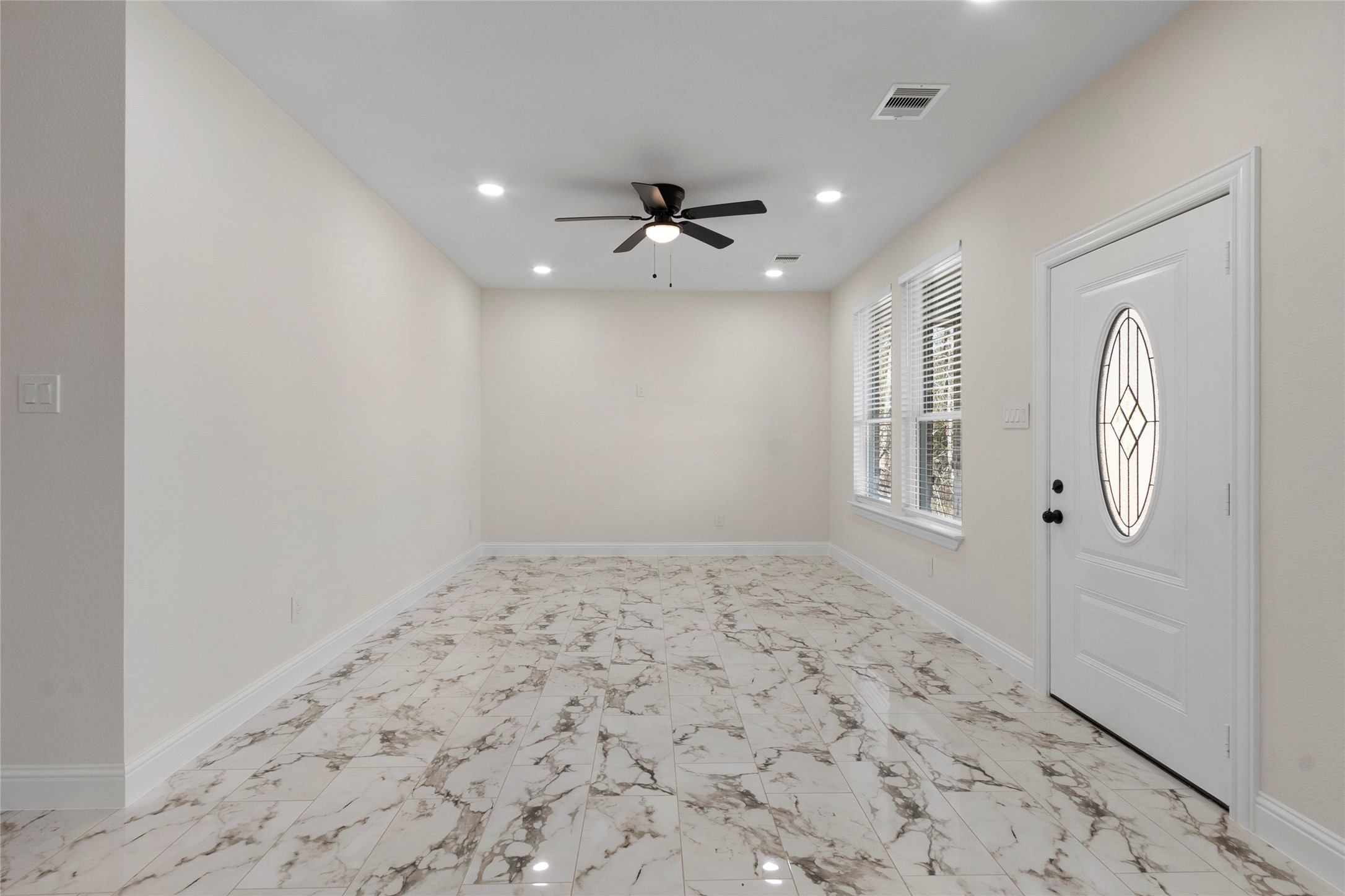 155 County Road 3372 Cleveland, TX 77327 - Photo 16 of 36 an empty room with windows and fan