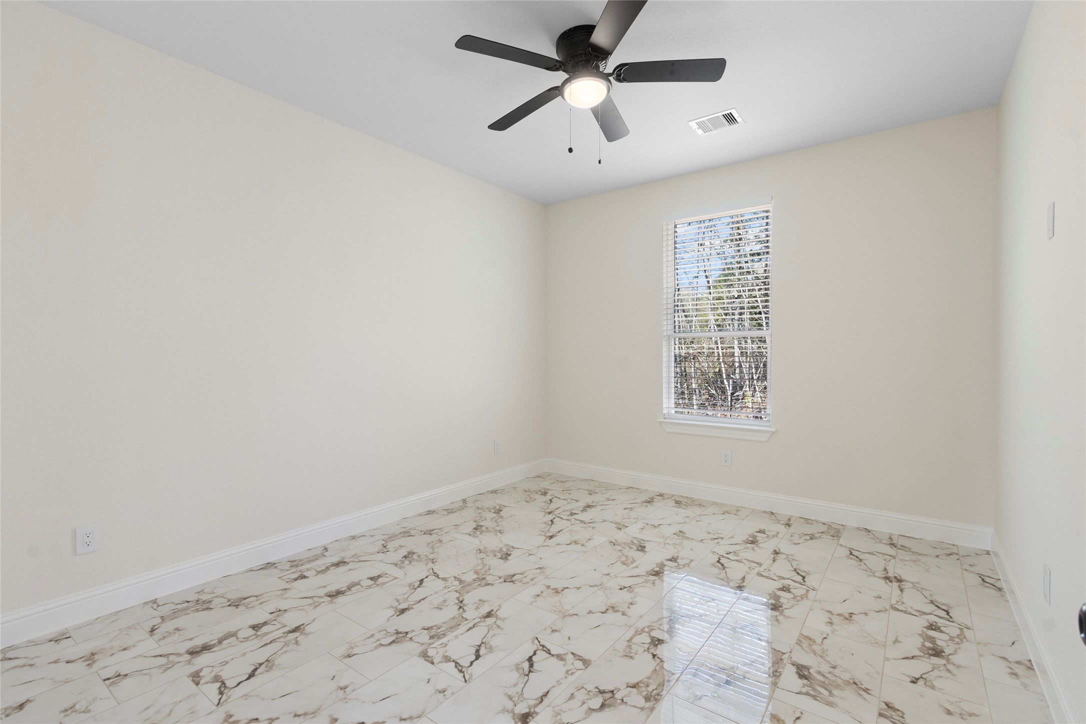 155 County Road 3372 Cleveland, TX 77327 - Photo 21 of 36 an empty room with a window