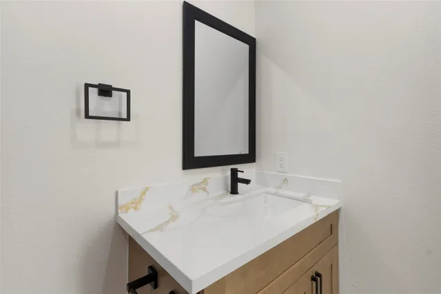 a bathroom with a sink and a mirror