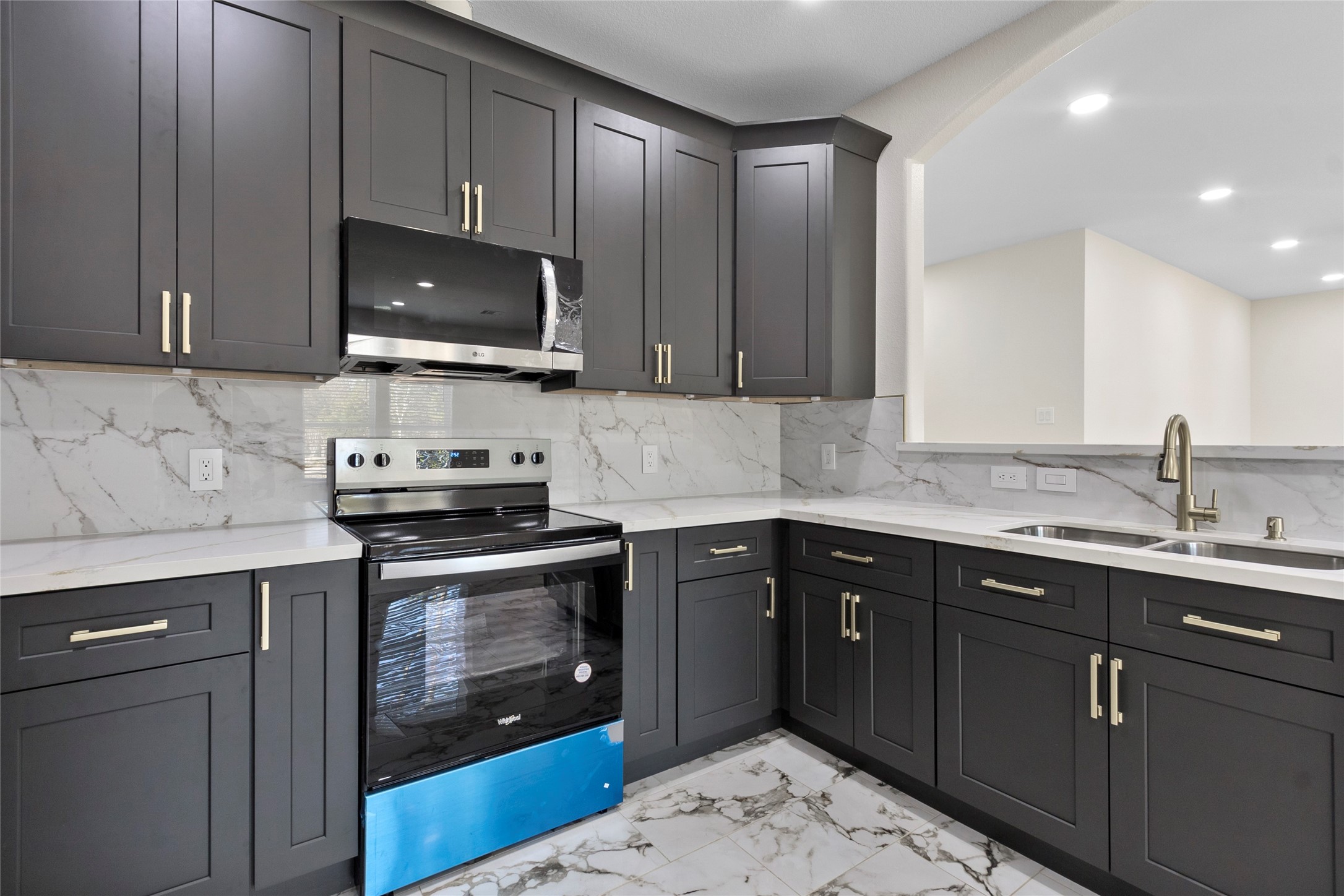 155 County Road 3372 Cleveland, TX 77327 - Photo 35 of 36 a kitchen with a sink stove and microwave
