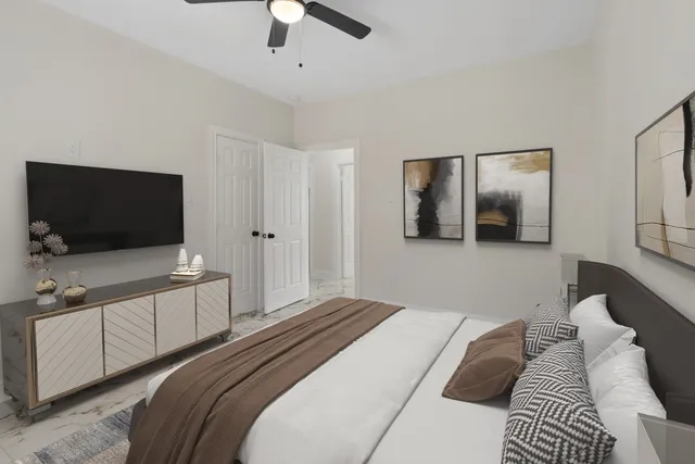 a bedroom with a bed and a flat screen tv