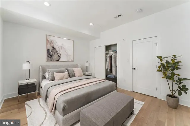 a bedroom with a bed and a potted plant