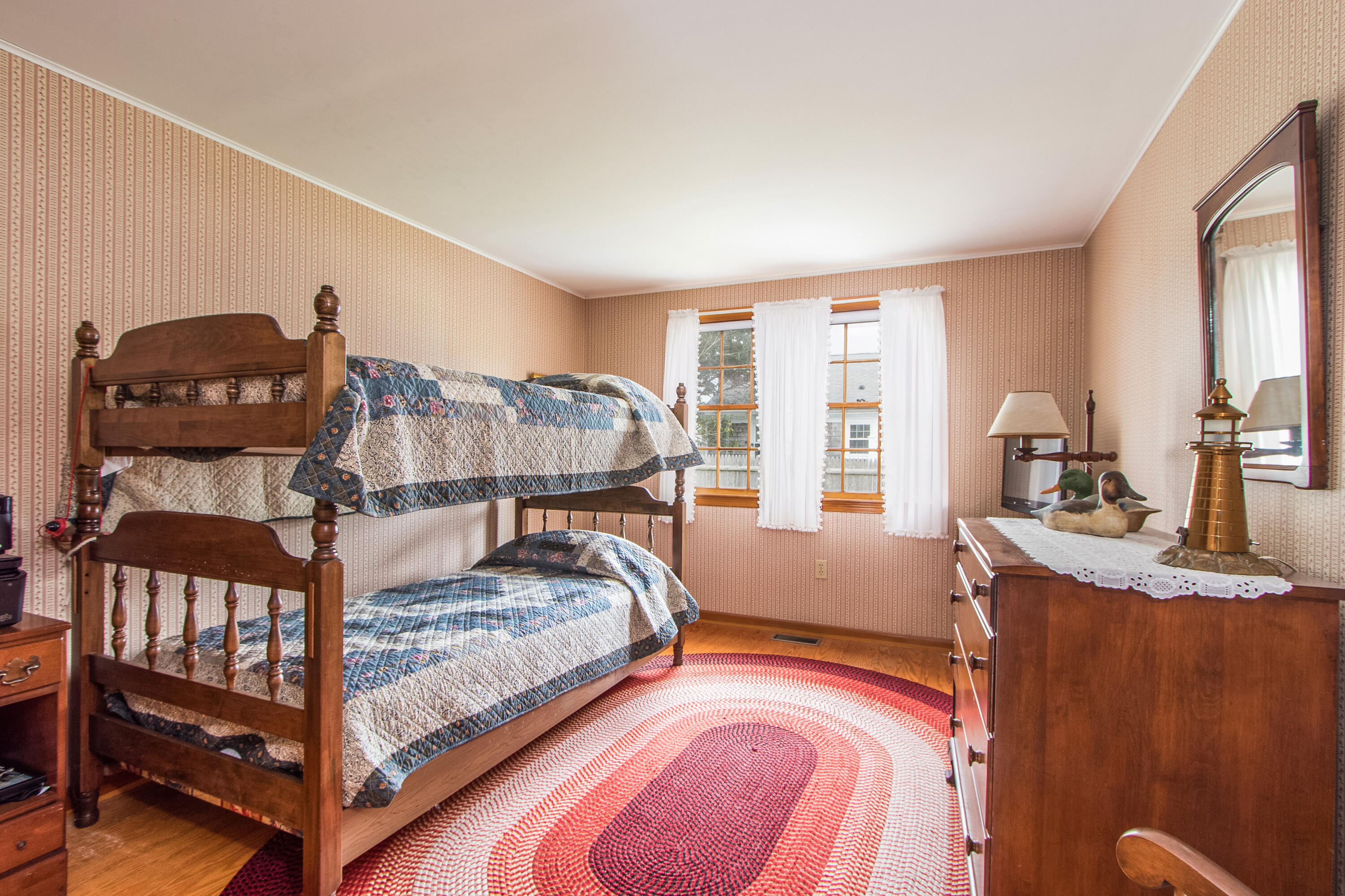 92 Surfside Road West Dennis, MA 02670 - Photo 26 of 38 a bedroom with a bed and large windows