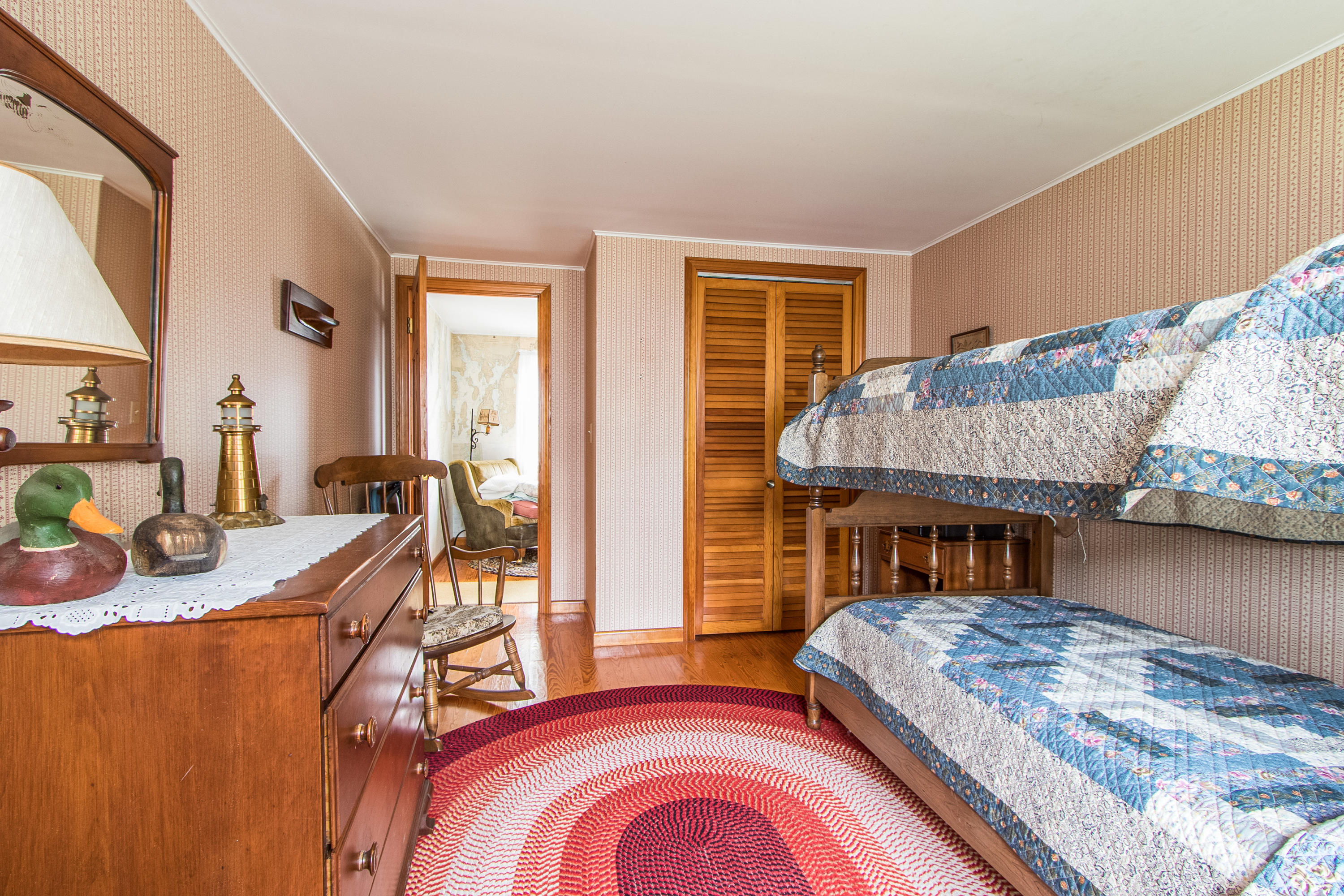 92 Surfside Road West Dennis, MA 02670 - Photo 27 of 38 a living room with a bed furniture and a wooden floor