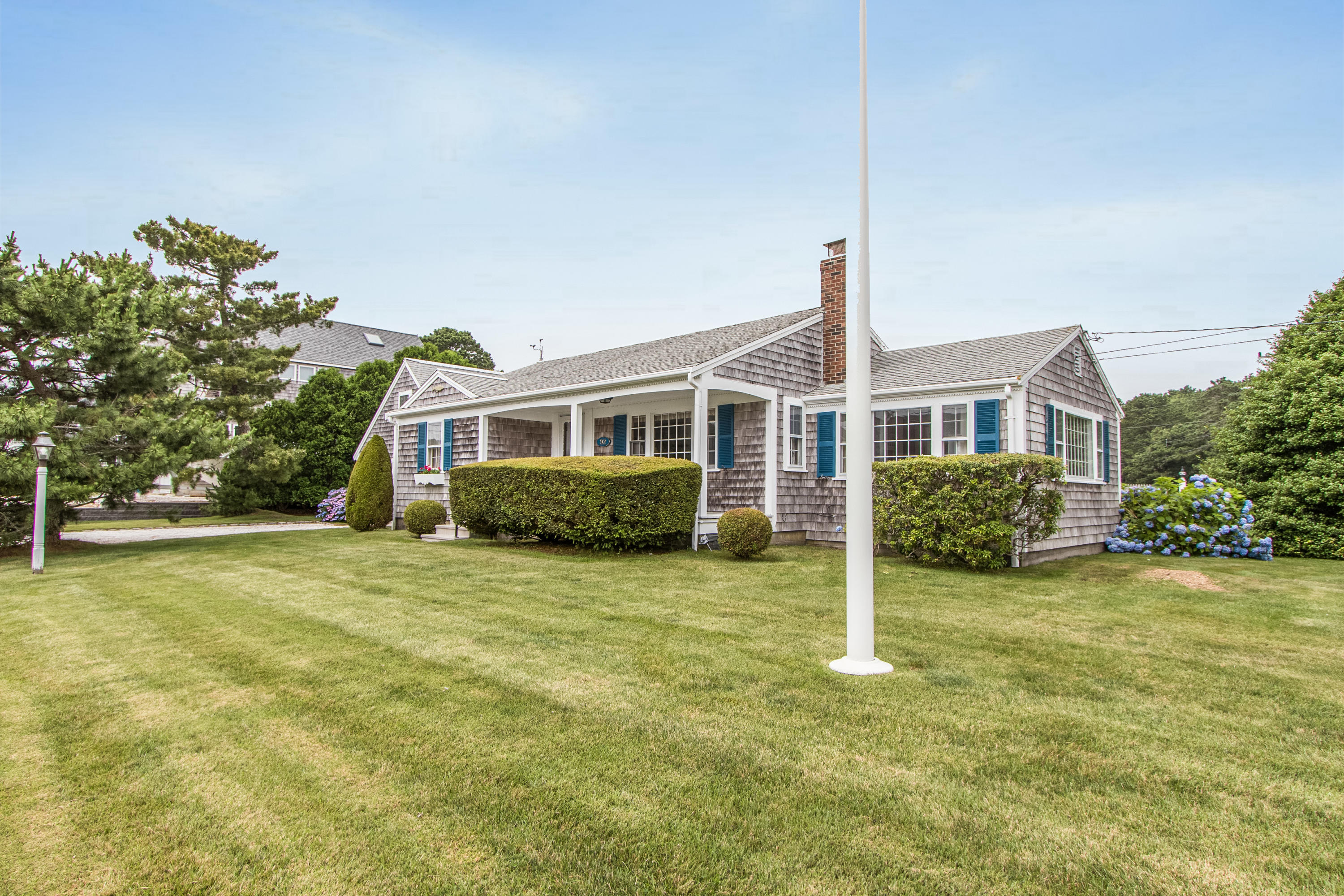 92 Surfside Road West Dennis, MA 02670 - Photo 3 of 38 a front view of a house with a yard