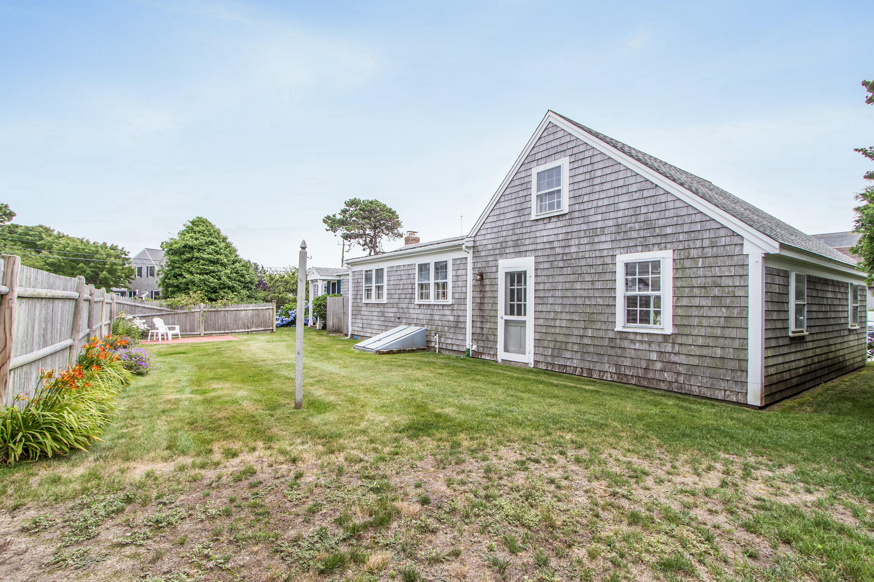 92 Surfside Road West Dennis, MA 02670 - Photo 34 of 38 a view of a house with backyard and sitting area