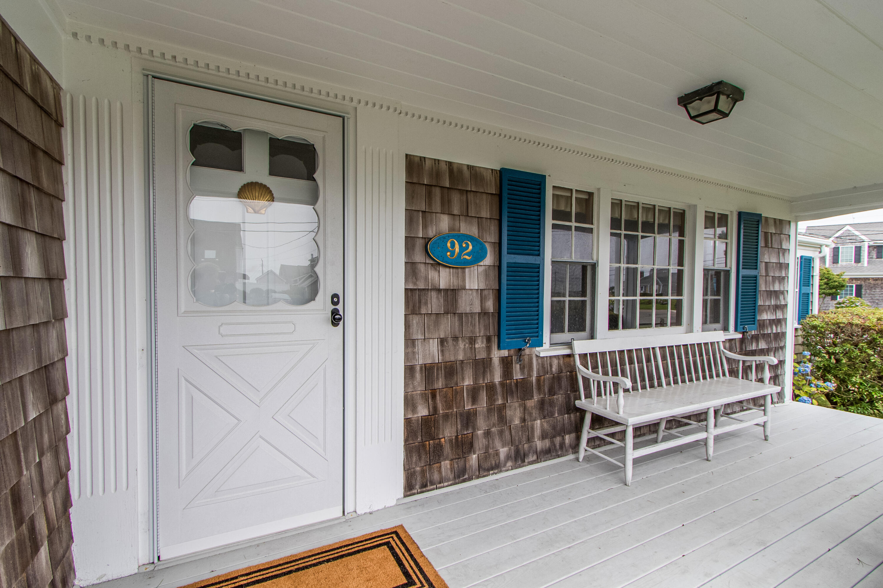92 Surfside Road West Dennis, MA 02670 - Photo 6 of 38 a view of front door with chair and deck
