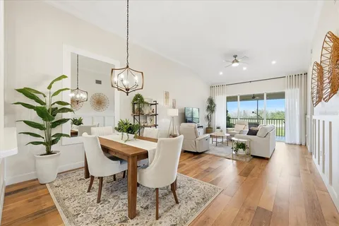 a living room with couches a coffee table and a potted plant