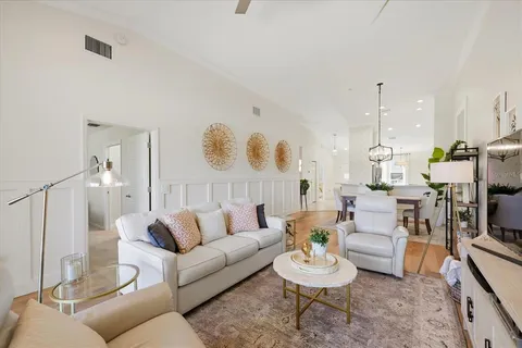 a living room with furniture and a chandelier