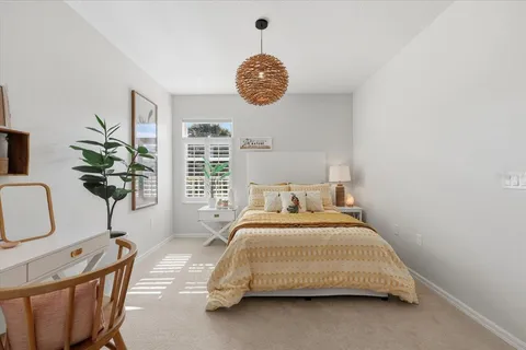 a bedroom with a bed and a chair in it