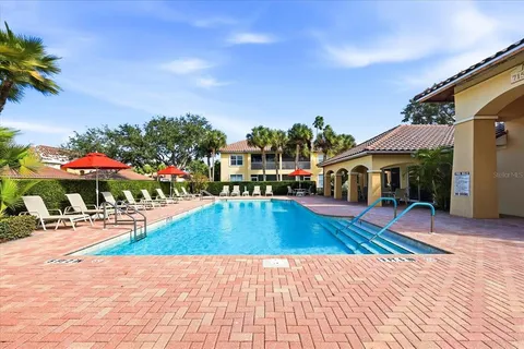 a view of swimming pool with a lounge chairs