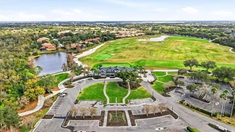 an aerial view of residential houses with outdoor space and trees