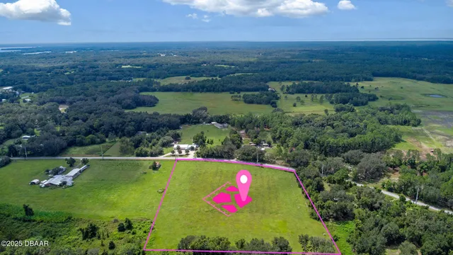 an aerial view of residential houses with outdoor space and lake view