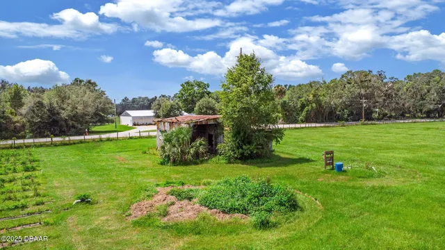 a yard with lots of green space and trees