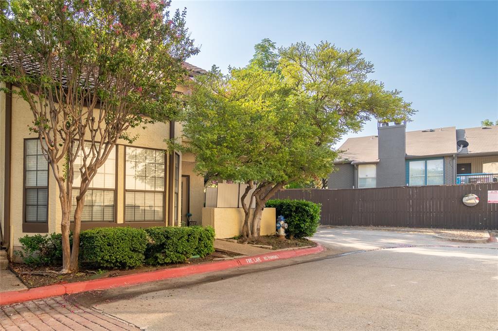 5590 Spring Valley Road, Unit F104 Dallas, TX 75254 - Photo 1 of 1 a front view of a house with a yard