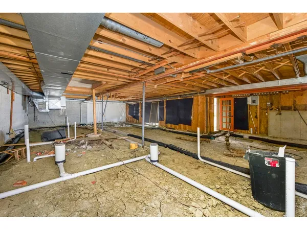 a view of a backyard with wooden floor and utility room