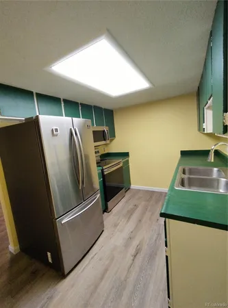 a kitchen with refrigerator and microwave