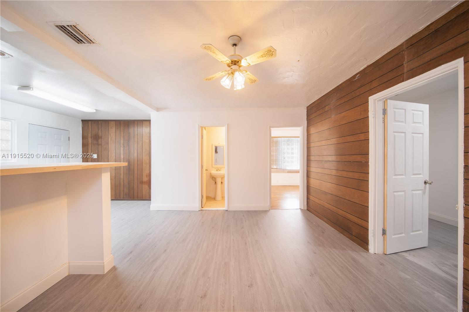 435 Southwest 33rd Avenue, Unit 4 Miami, FL 33135 - Photo 1 of 22 a view of an empty room with a window and wooden floor