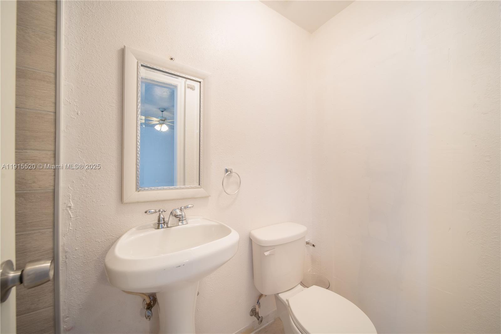 435 Southwest 33rd Avenue, Unit 4 Miami, FL 33135 - Photo 12 of 22 a bathroom with a toilet sink and mirror
