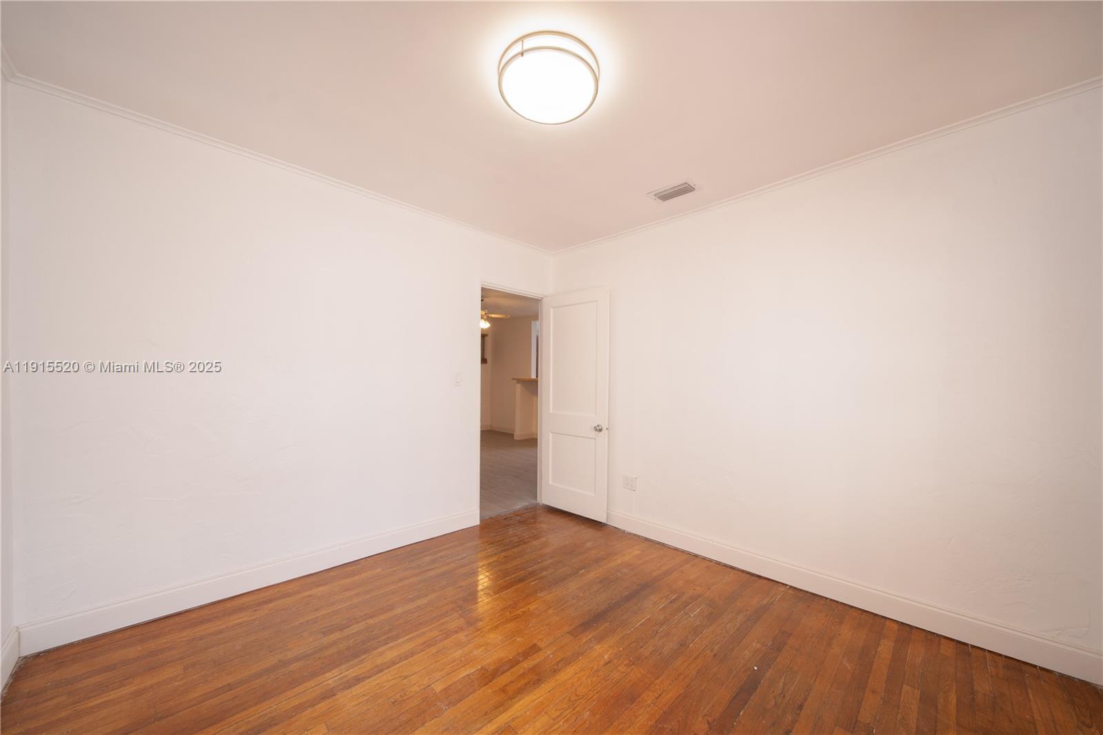 435 Southwest 33rd Avenue, Unit 4 Miami, FL 33135 - Photo 15 of 22 a view of a room with wooden floor and window