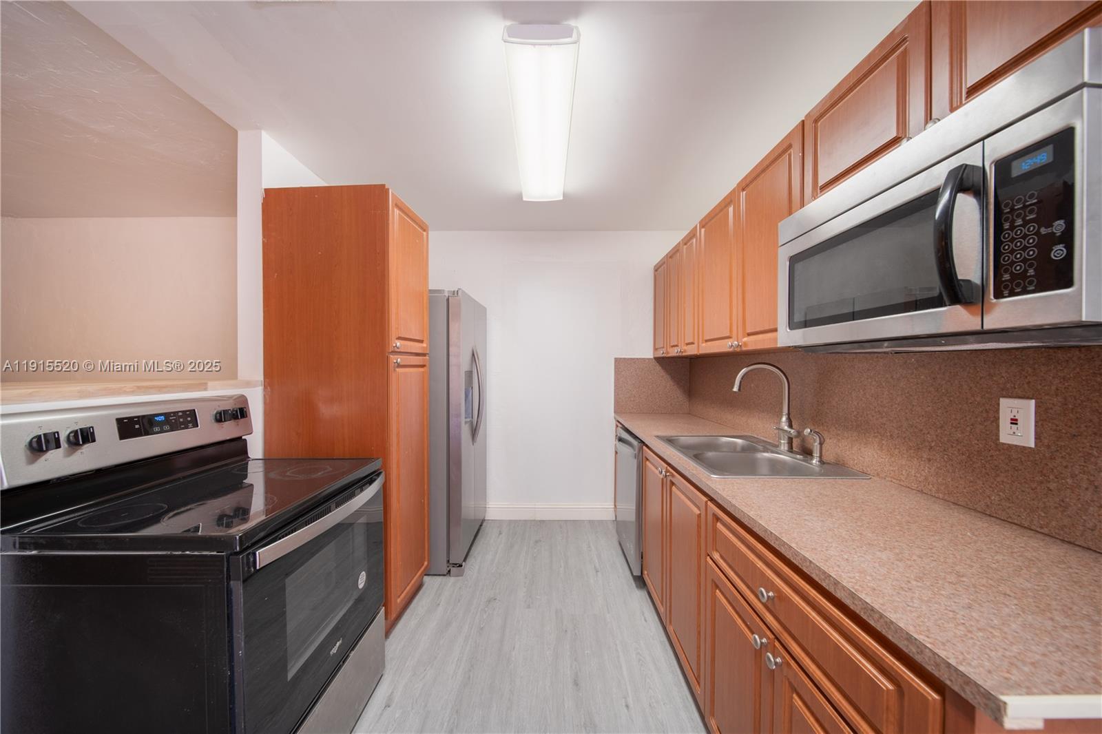 435 Southwest 33rd Avenue, Unit 4 Miami, FL 33135 - Photo 2 of 22 a kitchen with stainless steel appliances granite countertop a refrigerator a stove and a sink