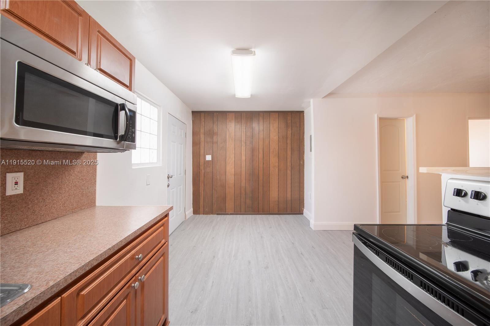 435 Southwest 33rd Avenue, Unit 4 Miami, FL 33135 - Photo 5 of 22 a kitchen with stainless steel appliances a stove and a microwave