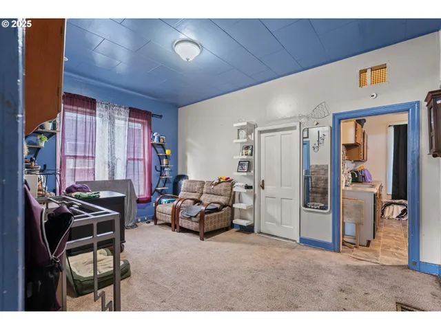 a living room with furniture a flat screen tv and a window