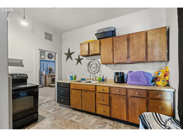 a kitchen with stainless steel appliances granite countertop a stove and cabinets