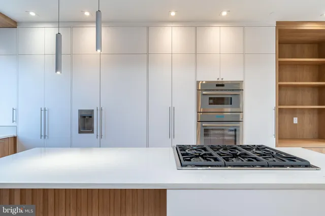 a view of an empty room with a fireplace and a window