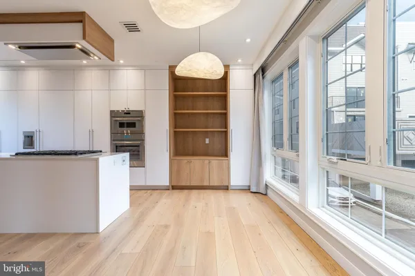 a kitchen with white cabinets and white appliances