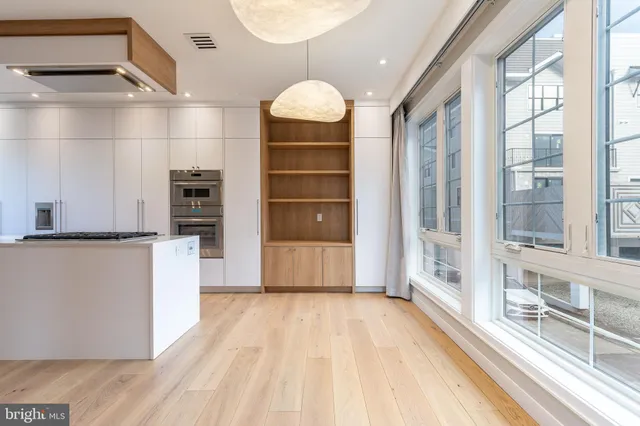 a kitchen with white cabinets and white appliances