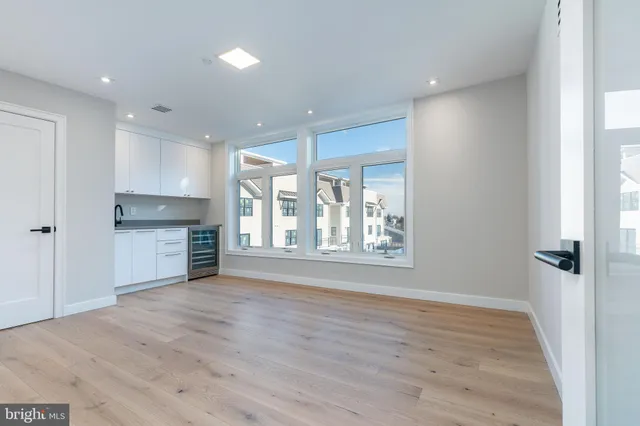 a view of a roof deck with couches and wooden floor
