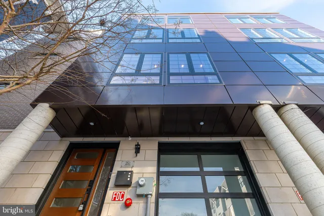 a kitchen with kitchen island a sink stainless steel appliances and cabinets