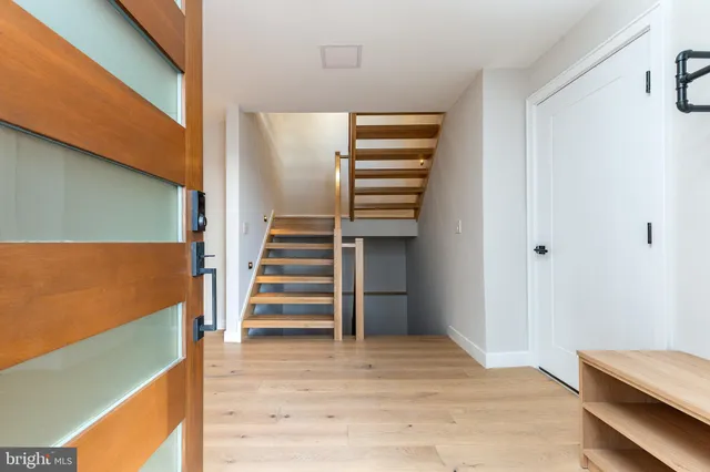 a room with wooden floor and windows