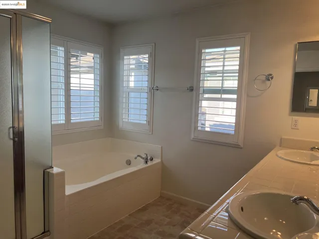 a bath tub sitting in a bathroom next to a window