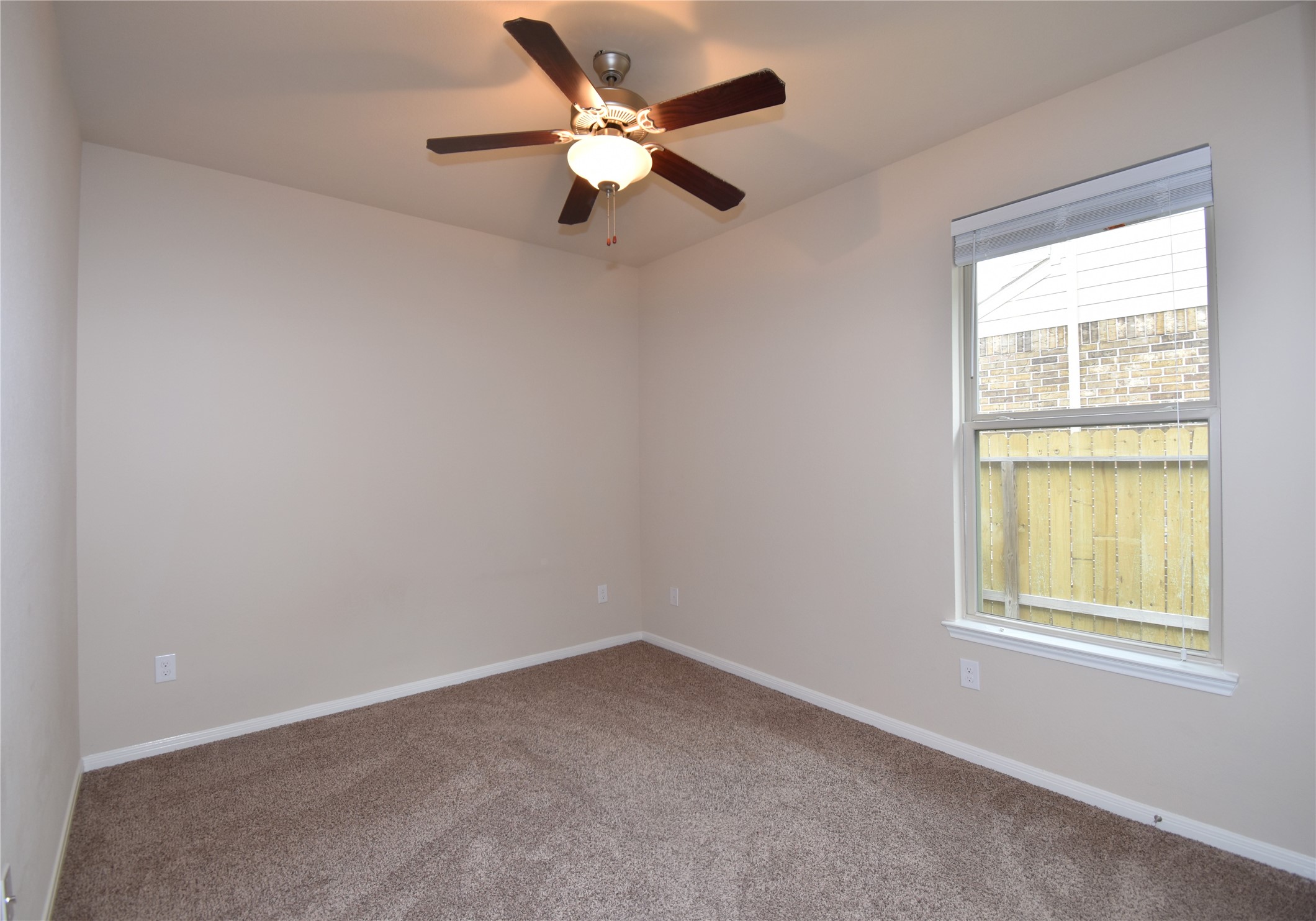 22219 Ebbets Field Drive Spring, TX 77389 - Photo 17 of 22 an empty room with a window and a fan