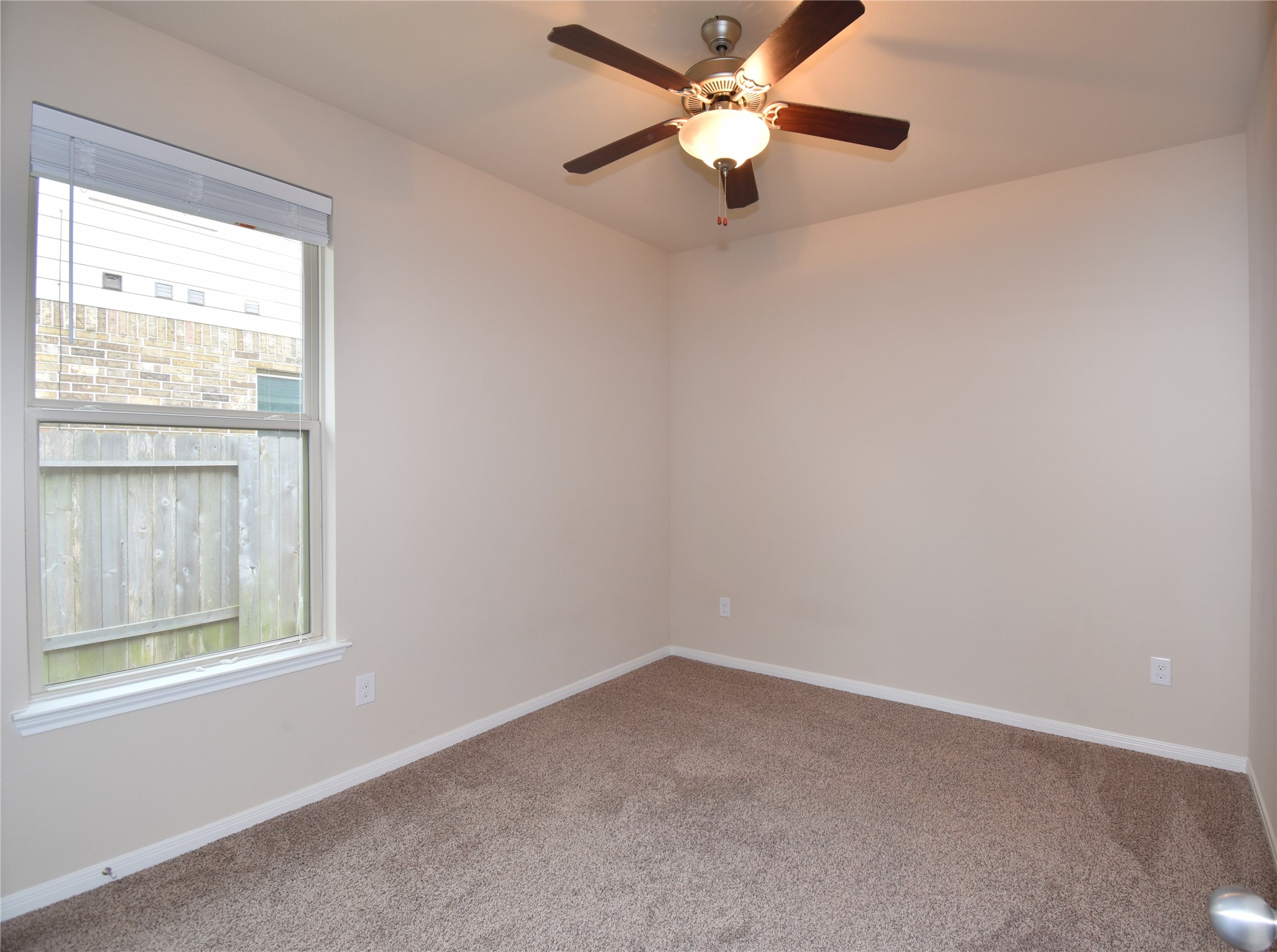 22219 Ebbets Field Drive Spring, TX 77389 - Photo 18 of 22 an empty room with a window and a fan