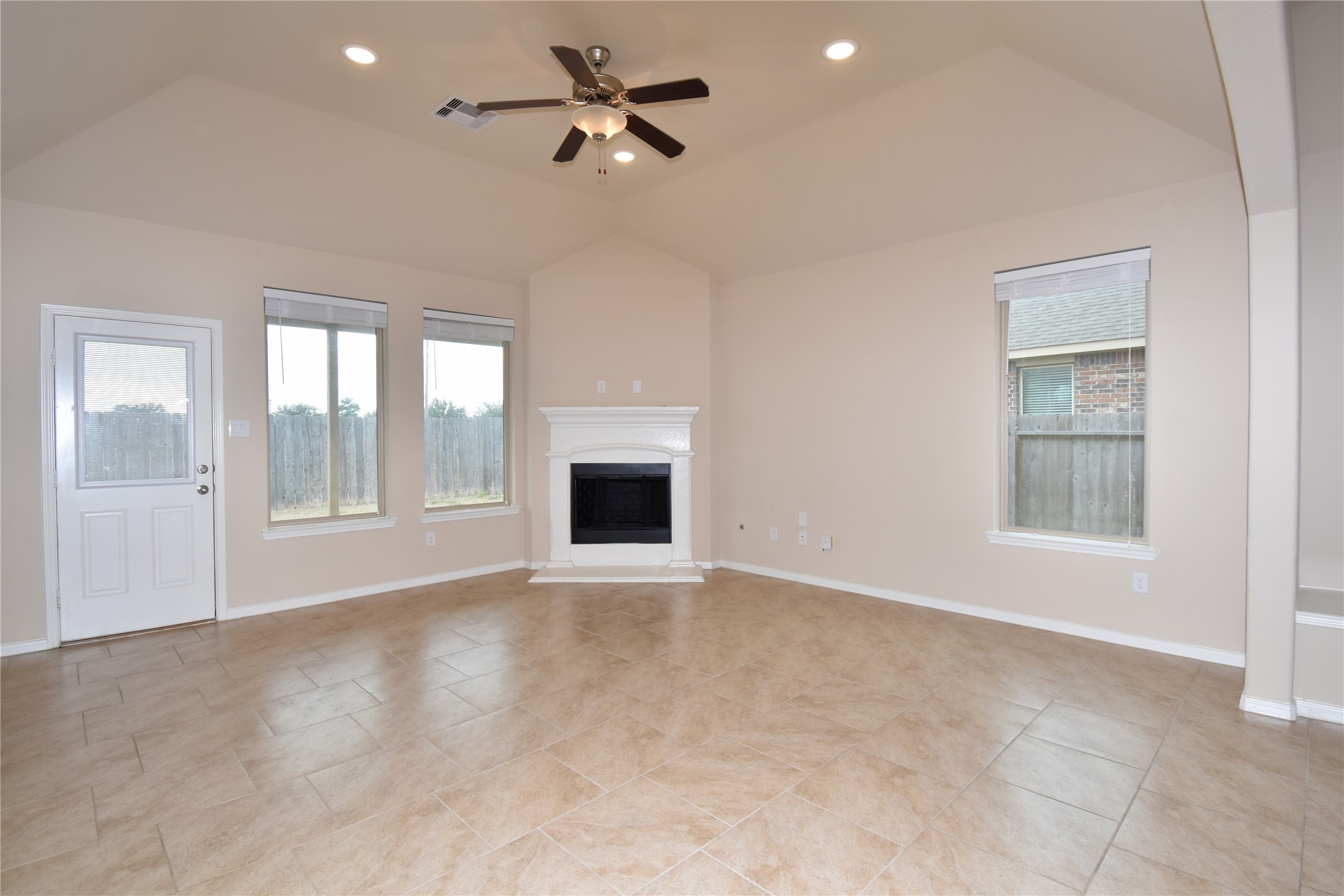22219 Ebbets Field Drive Spring, TX 77389 - Photo 19 of 22 a view of an empty room with a window and a kitchen