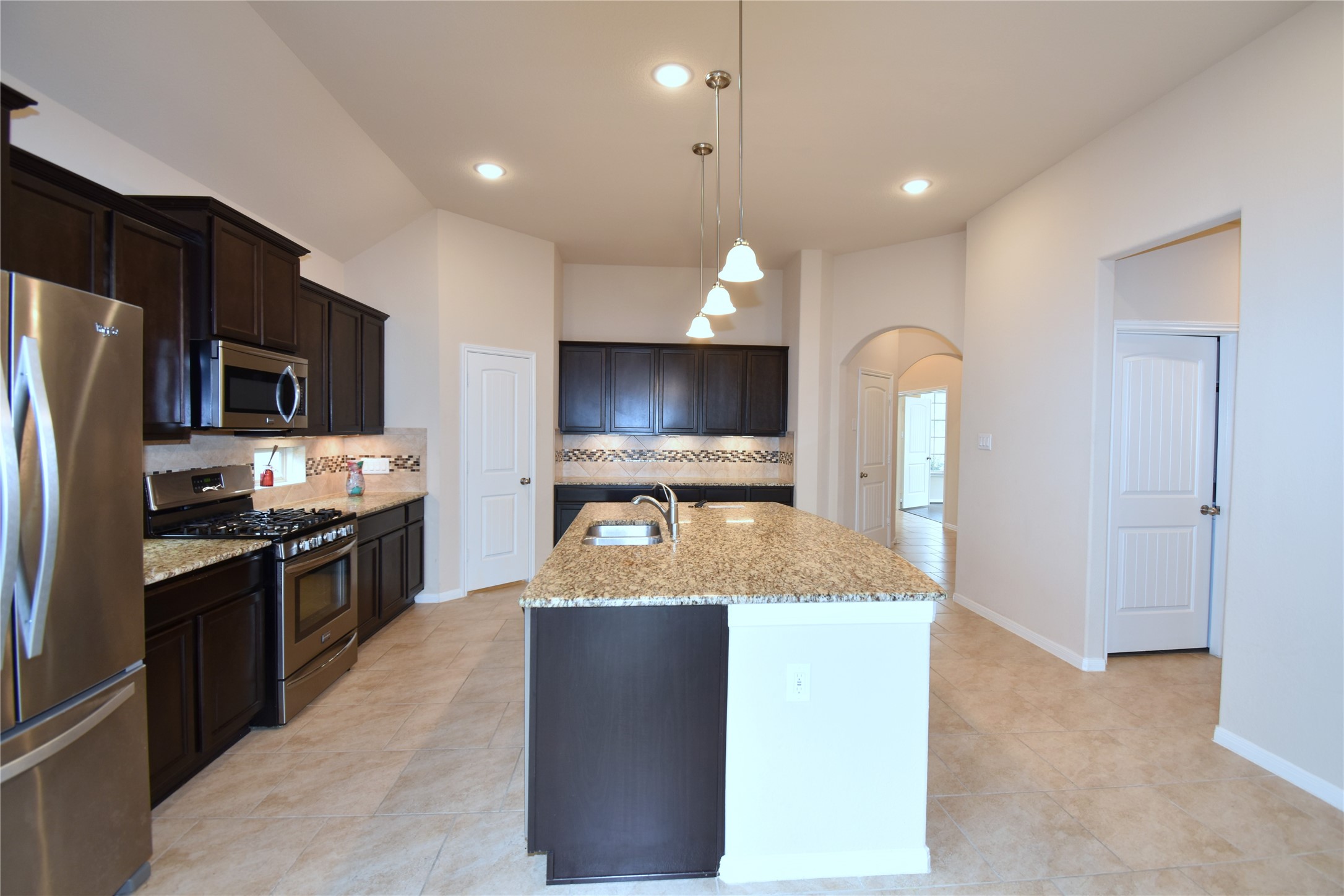 22219 Ebbets Field Drive Spring, TX 77389 - Photo 4 of 22 a large kitchen with a large counter top stainless steel appliances and cabinets