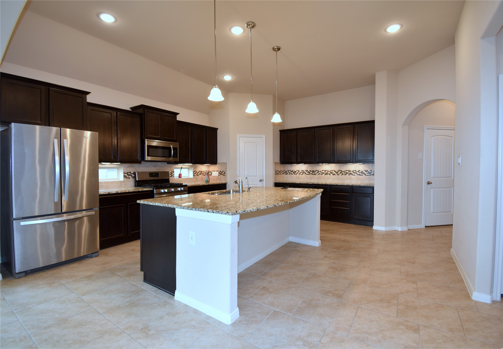 22219 Ebbets Field Drive Spring, TX 77389 - Photo 5 of 22 a large kitchen with a large counter top stainless steel appliances and cabinets