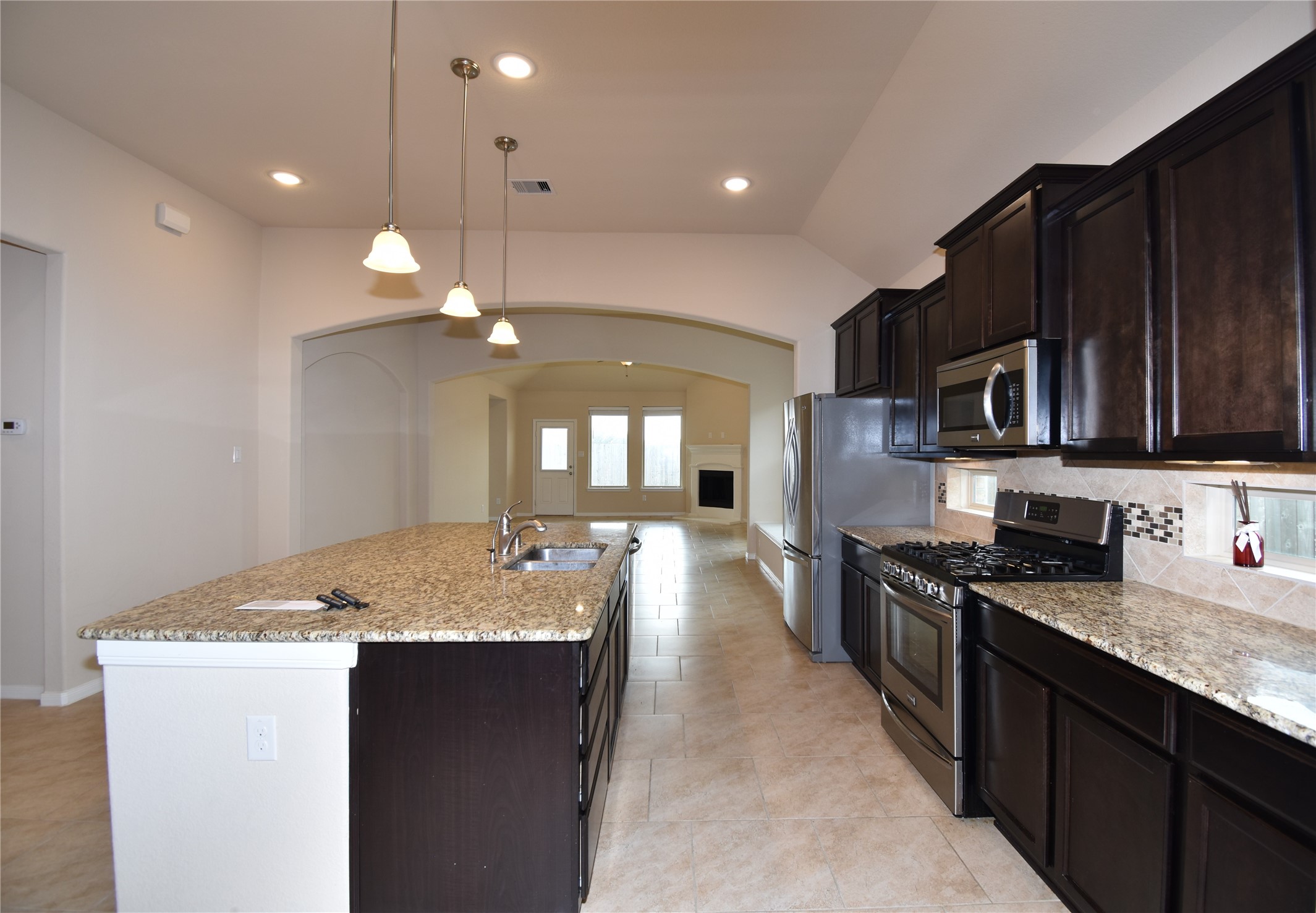 22219 Ebbets Field Drive Spring, TX 77389 - Photo 7 of 22 a kitchen with stainless steel appliances granite countertop a sink stove and refrigerator