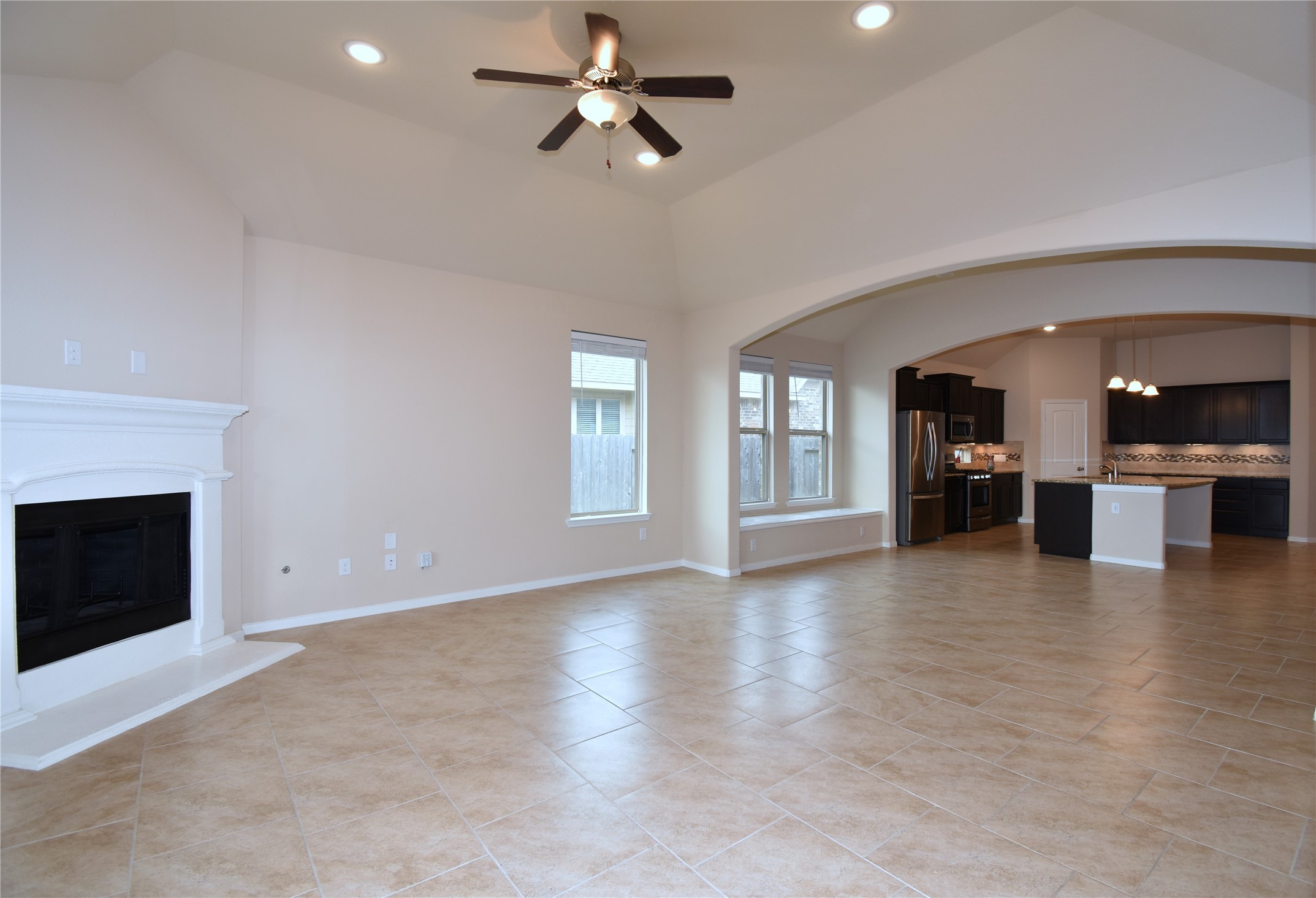 22219 Ebbets Field Drive Spring, TX 77389 - Photo 9 of 22 an empty room with fireplace chandelier and windows