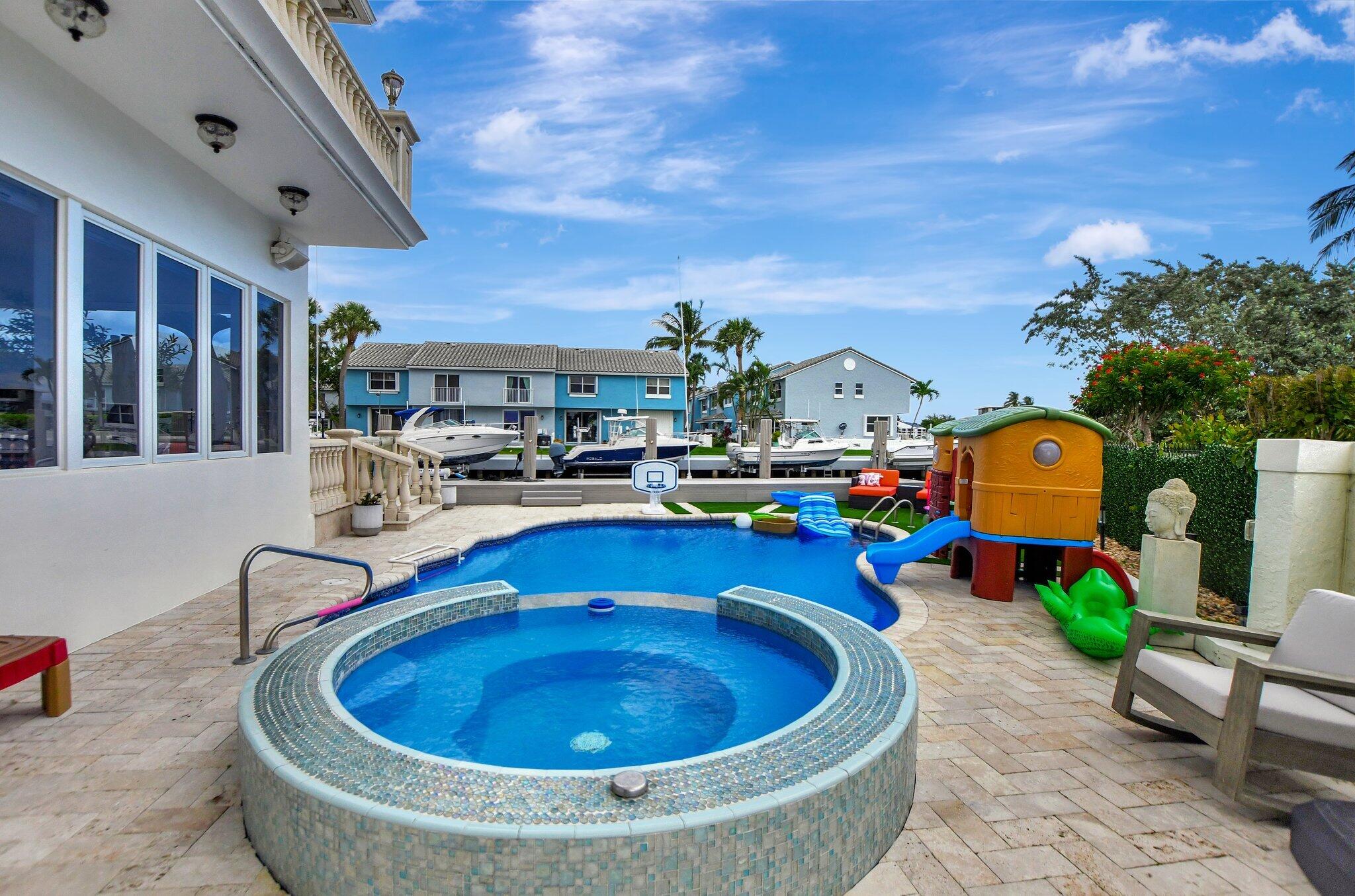 857 Havana Drive Boca Raton, FL 33487 - Photo 25 of 30 a swimming pool with outdoor seating and yard
